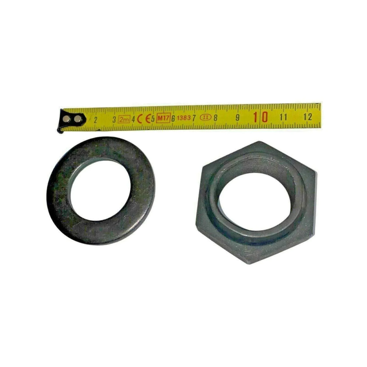 Pinion nut and round washer hardware kit for tractor, pictured with measuring tape