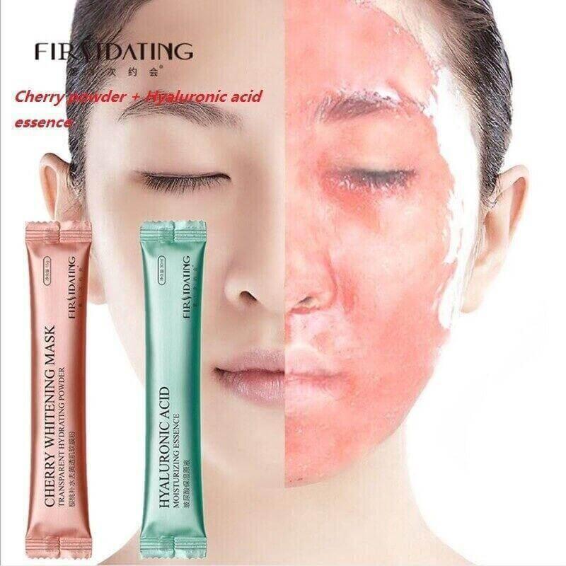 Woman with half face covered in pink hydrating jelly mask, showing cherry and hyaluronic acid mask packets