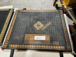 Aramid industrial mat with grid pattern and label, used for heavy-duty applications in workshops or warehouses.