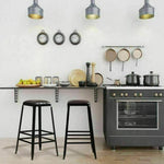 Pair of industrial black bar stools with leather seats in modern kitchen setting