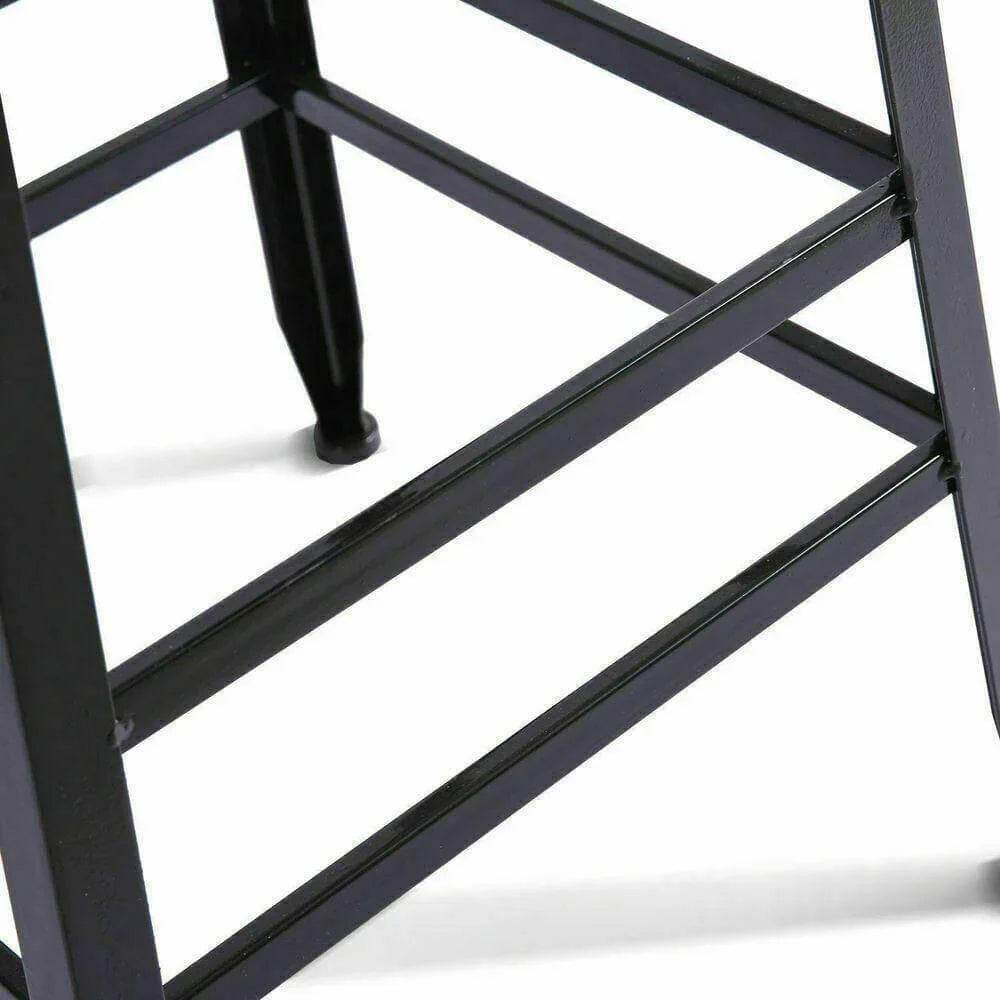 Close-up of black metal bar stool legs and footrest on white background