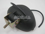 Black tractor work lamp with mounting bracket and attached wiring on white background