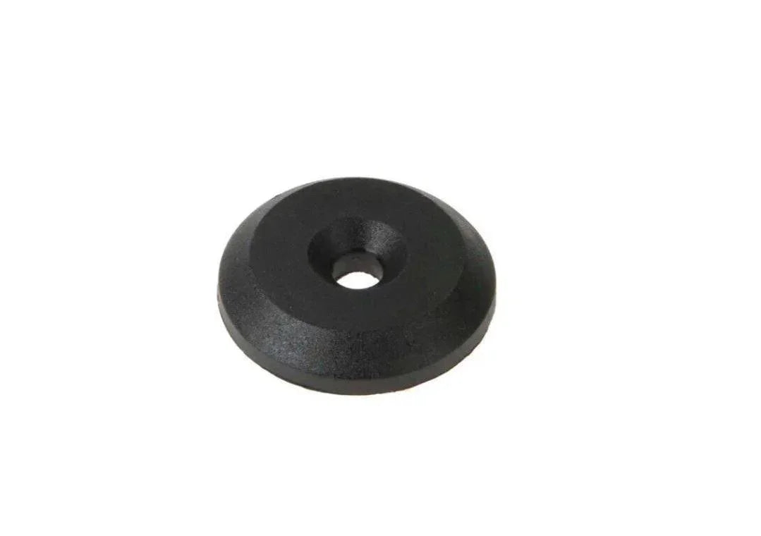 Black metal washer for tractor parts, circular with central hole, on white background