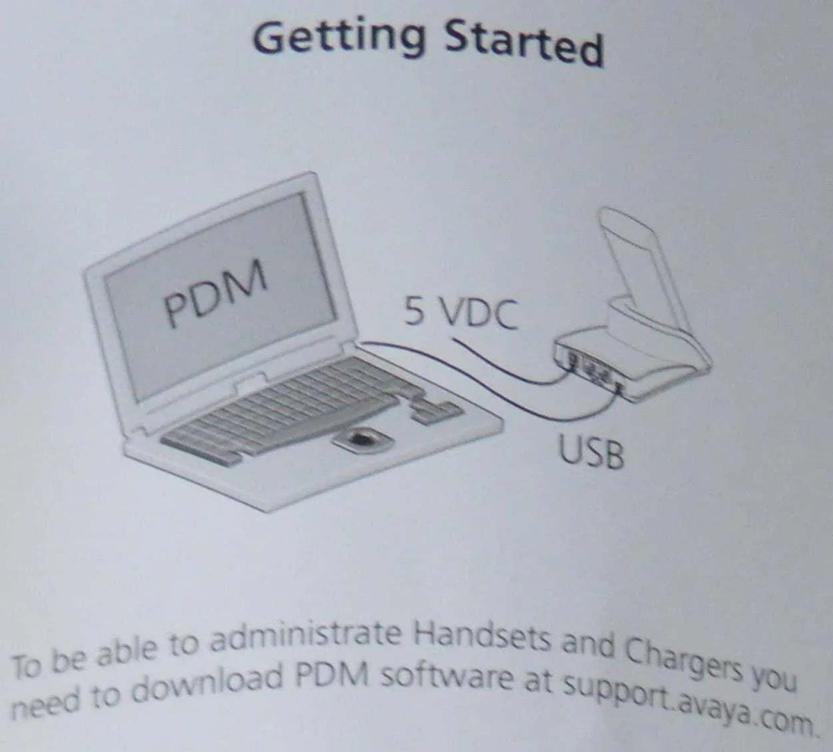 Diagram showing a laptop connected via USB to a charging dock labeled 5 VDC for office phone system setup.