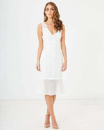 Woman wearing a sleeveless white lace midi dress with V-neck and flared hem, formal attire