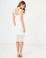 Woman wearing a white lace midi dress with double shoulder straps and flared hem, back view