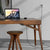 Wooden desk with laptop and matching stool in modern home office setup