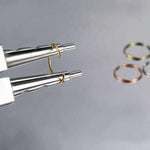 Assorted unisex fake nose rings in silver, gold and black, displayed with jewelry pliers